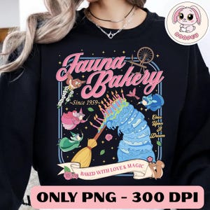 May include: Black sweatshirt with a whimsical "Fauna Bakery" design. The graphic features a blue cake, animated characters, and the text "Baked with Love & Magic." The design includes the text "Once Upon a Dream" and "Since 1959."