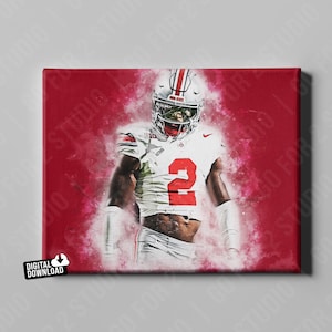 May include: A digital download canvas print featuring an American football player in a white and red uniform with the number 2. The player is wearing a helmet and pads, set against a red background with a smoky effect. The words "DIGITAL DOWNLOAD" are in the lower left corner.