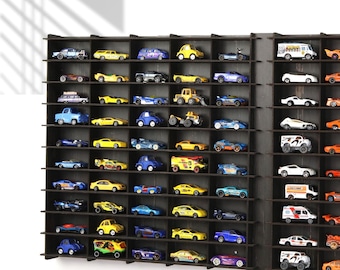 May include: A black wooden display shelf with multiple compartments for storing toy cars. The shelf is filled with a variety of colourful toy cars, including red, blue, yellow, and green cars.