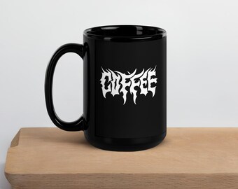 May include: Black ceramic coffee mug with a white "COFFEE" graphic in a stylized metal font.