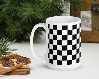May include: White ceramic mug with a black and white checkered pattern. The mug is 15 ounces and is dishwasher and microwave safe.
