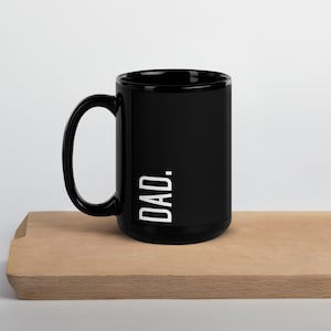 May include: Black ceramic mug with a white "DAD." inscription.