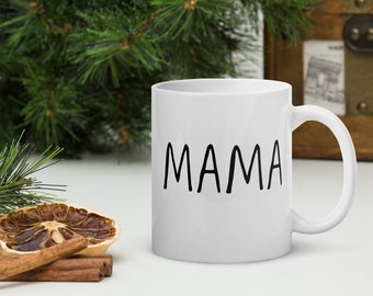 May include: White ceramic coffee mug with the word "MAMA" printed in black on the front.