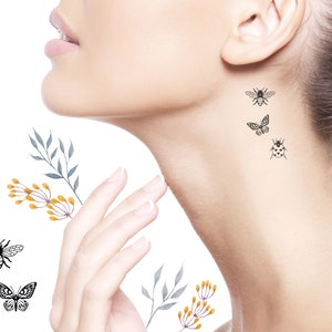 May include: A set of temporary tattoos featuring a bee, butterfly, and ladybug. The tattoos are black and white and are shown on a person's neck and shoulder.