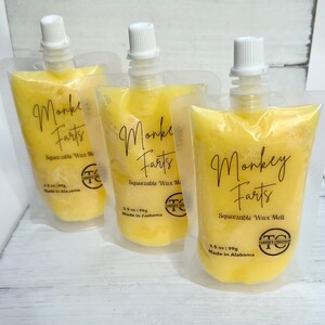 May include: Three yellow pouches of squeezable wax melt with the label "Monkey Farts" and the text "Squeezable Wax Melt" and "3.5 oz | 99g Made in Alabama".