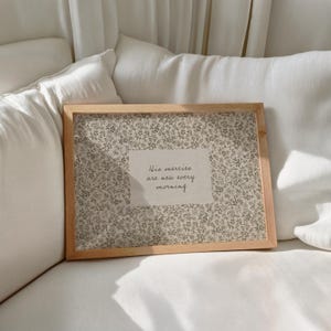 May include: A handmade wooden sign with the text "Welcome" in a playful font. The sign is painted white with a distressed finish, and features a decorative floral design in shades of pink and green. It measures approximately 12 inches wide.