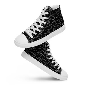 May include: High-top canvas sneakers with a black background covered in white mathematical equations and symbols. The sneakers have white laces, a white toe cap, and a white sole. The shoes are shown in a floating position.