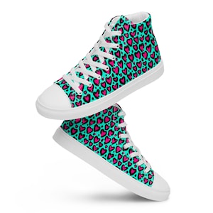 May include: White high-top canvas sneakers with a turquoise and pink heart pattern.