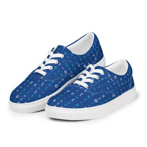 May include: A pair of blue canvas sneakers with a white sole and white laces. The shoes are covered in a pattern of white and light blue binary code symbols. The sneakers are a low-top style.