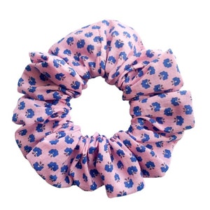 May include: A pink scrunchie with a blue floral pattern.