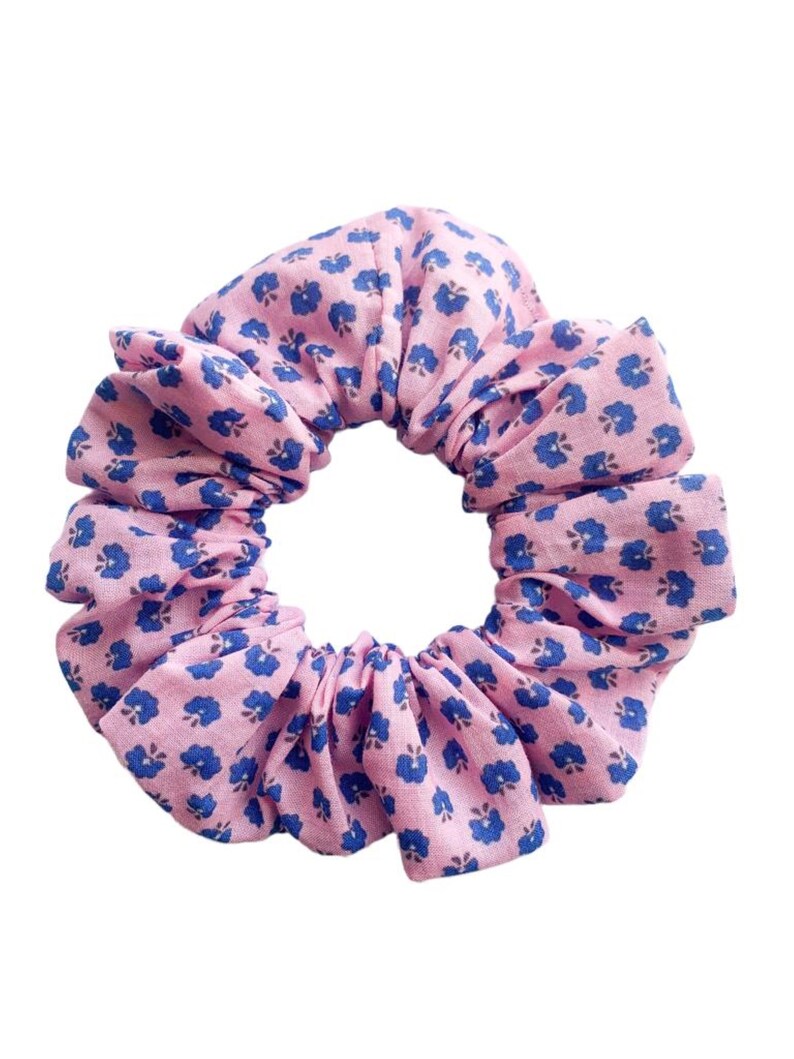May include: A pink scrunchie with a blue floral pattern.