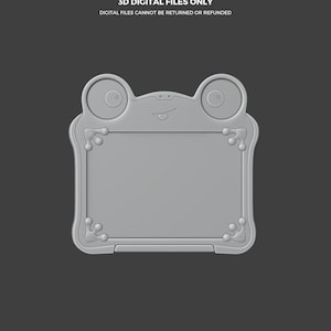 Puede incluir: Un dise&ntilde;o de archivo digital 3D gris con forma de rana. El dise&ntilde;o presenta un centro rectangular con esquinas redondeadas y elementos decorativos. El texto "THIS IS NOT A TOY" y "3D DIGITAL FILES ONLY" se muestra arriba. El logotipo de Abyssmo Workshop est&aacute; en la parte inferior.