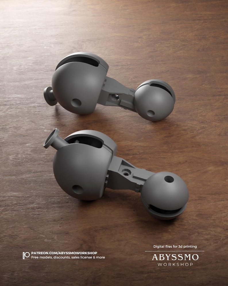 May include: Two gray, articulated 3D-printed components are displayed on a wooden surface. Each component has a spherical shape with a connecting arm and a smaller sphere. The image includes text: "Digital files for 3d printing" and "ABYSSMO WORKSHOP."