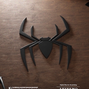 May include: Black 3D printed spider design on a wooden surface. Digital files for 3D printing are available at Patreon.com/AbyssmoWorkshop.  Free models, discounts, sales license & more.