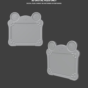 Puede incluir: Dos archivos digitales grises con forma de rana, con el texto "THIS IS NOT A TOY" y "3D DIGITAL FILES ONLY". Los archivos tienen un marco rectangular con esquinas decorativas y una cara de rana en la parte superior. La parte inferior de la imagen tiene el texto "ABYSSMO WORKSHOP".