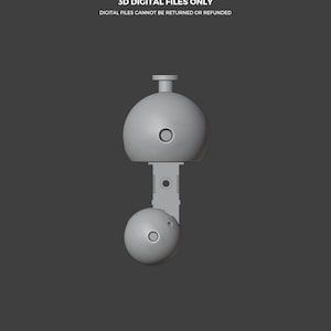 May include: A gray 3D model of a toy-like object, featuring two spherical components connected by a rectangular piece. The text "THIS IS NOT A TOY" and "3D DIGITAL FILES ONLY" are displayed at the top. The bottom of the image includes the text "ABYSSMO WORKSHOP".