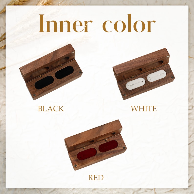 May include: Three wooden ring boxes with different coloured interiors. The first box has a black interior, the second box has a white interior, and the third box has a red interior.  Inner color.