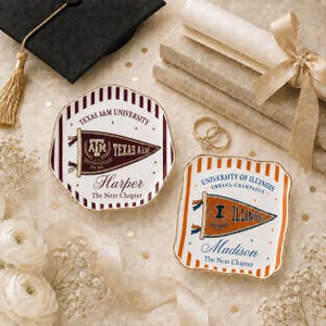 May include: Two ceramic trinket dishes with scalloped edges. One features a maroon Texas A&M University pennant graphic with the name Harper, the other an orange University of Illinois pennant graphic with the name Madison. Both include the text The Next Chapter.