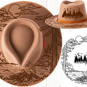 May include: A tan fedora-style hat with a wide brim, featuring a forest and campfire design etched into the brim. The hat has the word "HAPPY" and a forest silhouette on the crown. The hat is a camping-themed accessory.