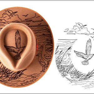 May include: A tan fedora hat with a detailed illustration of seagulls and a coastal scene. The hat features a central design of a bird in flight, surrounded by other birds and water elements. The brim is decorated with a similar coastal design.