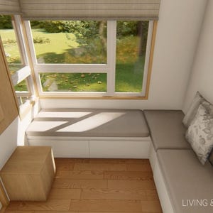 May include: Interior design rendering of a living and dining area. Features a built-in bench with cushions, a wooden side table, and a large window overlooking a green landscape. Decorative mirrors and pillows add to the cozy atmosphere.