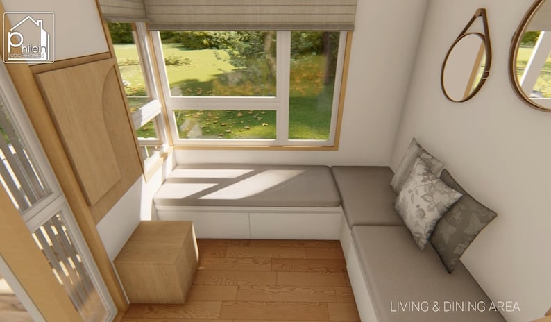May include: Interior design rendering of a living and dining area. Features a built-in bench with cushions, a wooden side table, and a large window overlooking a green landscape. Decorative mirrors and pillows add to the cozy atmosphere.
