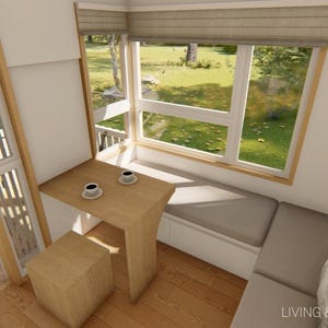 May include: Interior view of a small living and dining area. A wooden table with two coffee cups sits near a large window with a built-in bench. A small wooden stool is next to the table. The text "LIVING & DINING AREA" is visible.