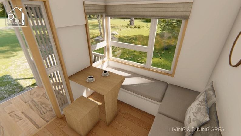 May include: Interior view of a small living and dining area. A wooden table with two coffee cups sits near a large window with a built-in bench. A small wooden stool is next to the table. The text "LIVING & DINING AREA" is visible.
