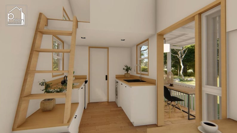 May include: Interior view of a tiny house with a wooden ladder, white cabinets, and a small kitchen area. A window and door frame the view of an outdoor patio. The house has a minimalist design with light wood and white walls.