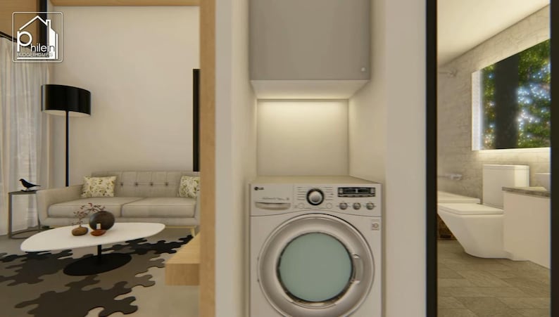 May include: Interior view of a modern home with a laundry area and a glimpse of a bathroom. The laundry area features a washing machine and a storage cabinet. A sofa, coffee table, and lamp are visible in the living area.