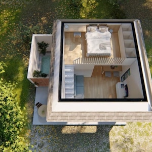 May include: An aerial view of a modern, two-story tiny home with a flat roof. The upper level features a bedroom, while the lower level has a living area. A small outdoor patio and a hot tub are also visible. The home is surrounded by green trees and grass.