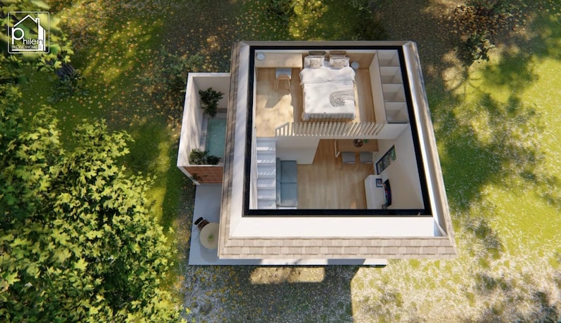 May include: An aerial view of a modern, two-story tiny home with a flat roof. The upper level features a bedroom, while the lower level has a living area. A small outdoor patio and a hot tub are also visible. The home is surrounded by green trees and grass.