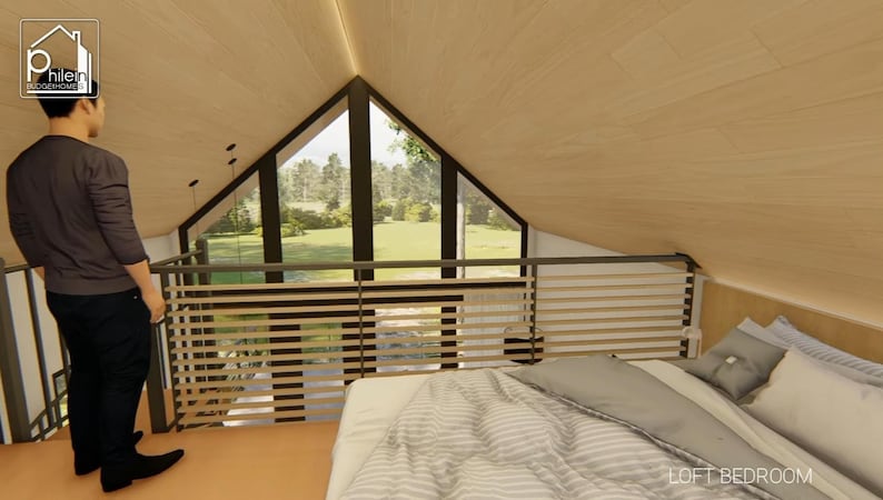 May include: Interior view of a loft bedroom with a bed, pillows, and a window overlooking a green landscape. The room has wooden paneling on the walls and ceiling. A person is standing near the railing. The words "LOFT BEDROOM" are visible.
