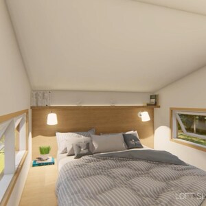 May include: Interior view of a loft bedroom with a bed, pillows, and a gray and white striped comforter. The room has two windows, a wooden headboard, and two hanging lamps. The text "LOFT SLEEPING AREA" is visible.