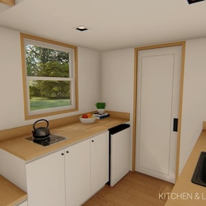 May include: Interior view of a small kitchen and laundry area. The kitchen features white cabinets, a wooden countertop, and a black stovetop with a kettle. A window offers a view of the outdoors. The text "KITCHEN & LAUNDRY AREA" is visible.