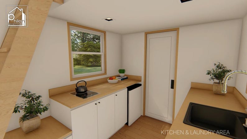 May include: Interior view of a small kitchen and laundry area. The kitchen features white cabinets, a wooden countertop, and a black stovetop with a kettle. A window offers a view of the outdoors. The text "KITCHEN & LAUNDRY AREA" is visible.