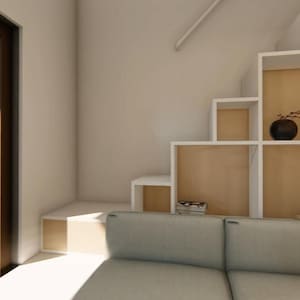 May include: Interior view of a modern living space with a built-in staircase and shelving unit. The shelves are white with a light wood backing. A gray sofa is in the foreground. A large window offers a view of the outdoors.