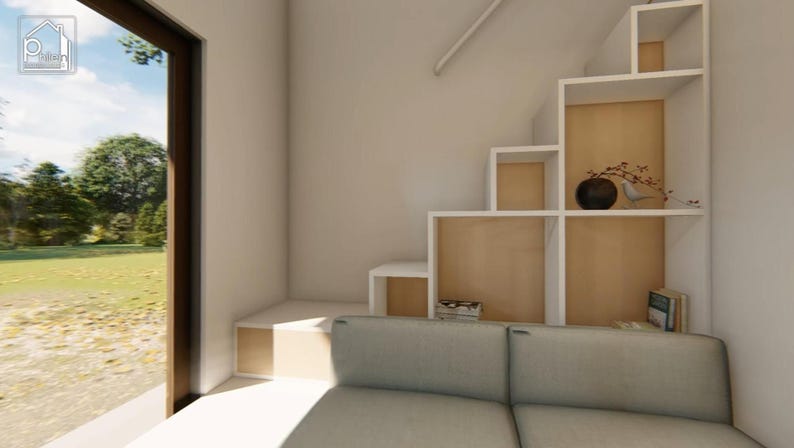 May include: Interior view of a modern living space with a built-in staircase and shelving unit. The shelves are white with a light wood backing. A gray sofa is in the foreground. A large window offers a view of the outdoors.
