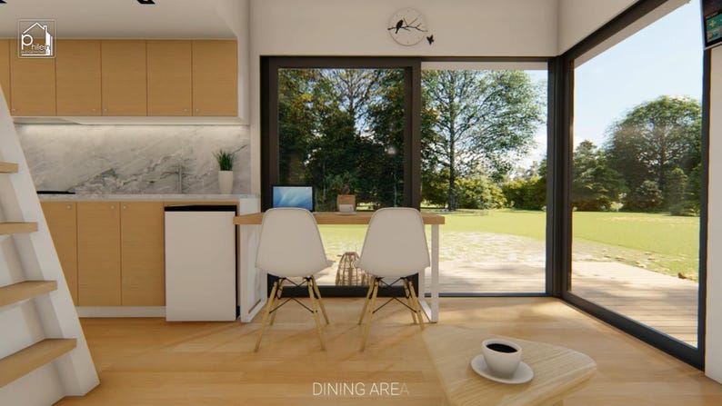 Puede incluir: Vista interior de un comedor moderno con suelo y armarios de madera clara. Cuenta con un peque&ntilde;o escritorio con dos sillas blancas, un port&aacute;til y una mesa de centro con una taza de caf&eacute;. Grandes ventanales ofrecen vistas a un c&eacute;sped verde.