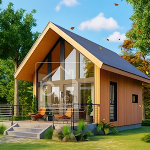 May include: A modern, small cabin with a gabled roof and large glass windows. The exterior features light brown wood siding and a dark gray roof. The cabin has a small porch with two chairs and a black railing, surrounded by trees and green grass.