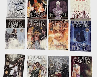 May include: A collection of twelve "Game of Thrones" comic books by George R.R. Martin. The covers feature various illustrations in a range of colors, with the title and author's name prominently displayed. The HBO logo is visible on each book.