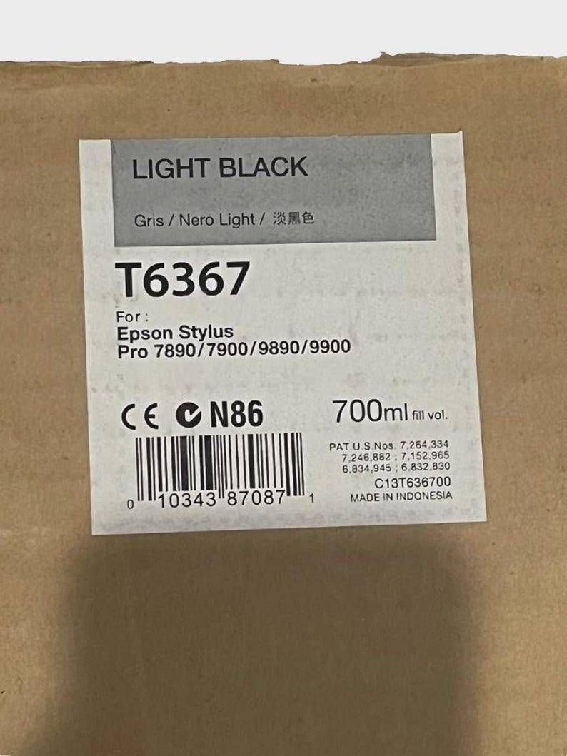 May include: A rectangular label for Epson Stylus Pro ink cartridge, labeled "LIGHT BLACK". The label includes the model number T6367, the ink volume of 700ml, and the text "MADE IN INDONESIA".
