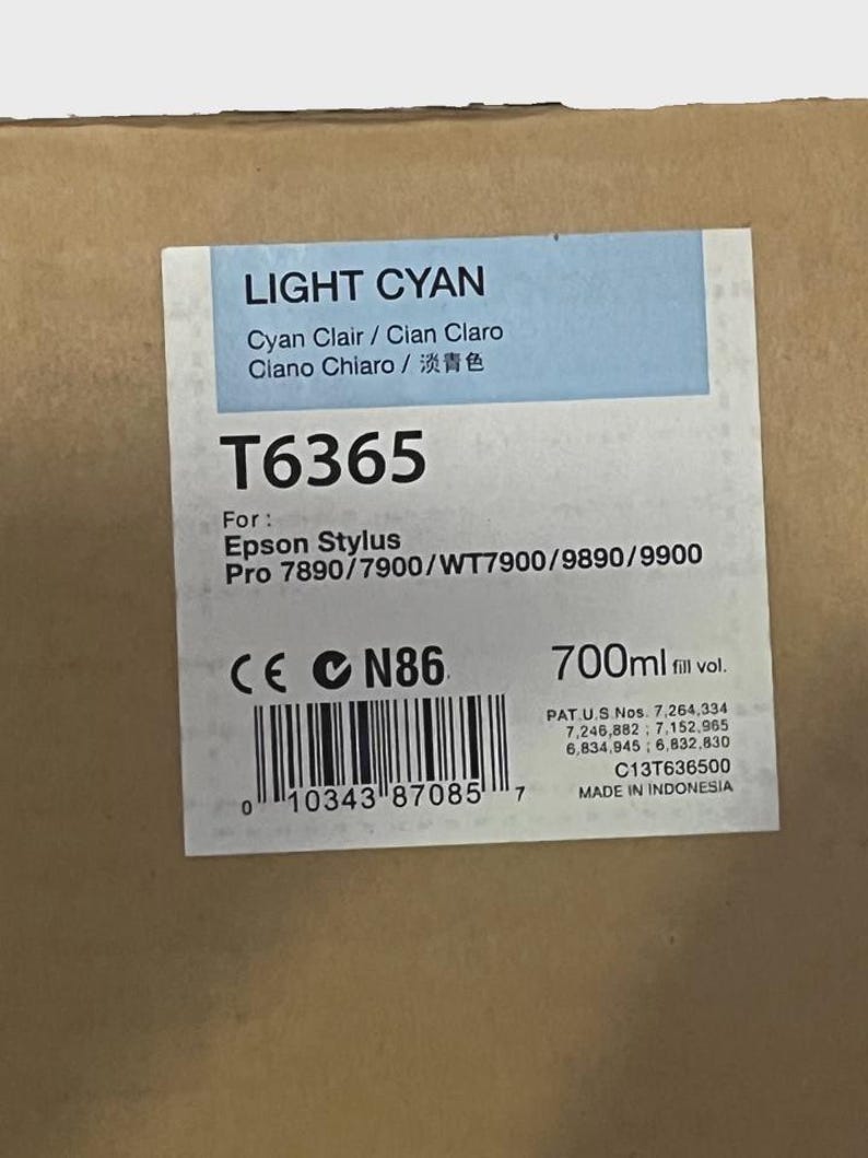 May include: A rectangular box with a label that reads "LIGHT CYAN" in blue and white. The label also includes the text "T6365" and "700ml fill vol." The box is for Epson Stylus Pro printers.