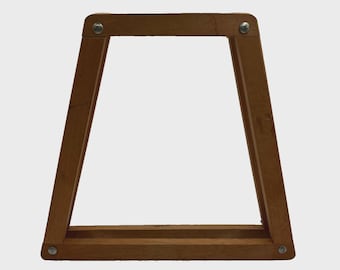 May include: A wooden, trapezoid-shaped stand with a natural brown finish. The stand is constructed with four wooden beams joined at the corners with silver-colored screws. The design is simple and functional, suitable for display.