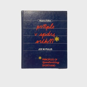 May include: A navy blue book titled "Principles of Speedwriting Shorthand" by Joe M. Pullis. The cover features stylized orange text and a yellow asterisk. The book is a "Regency Edition."