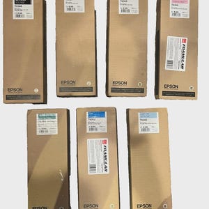 May include: Seven Epson ink cartridge boxes in various colors. The boxes are rectangular, made of cardboard, and have labels with product information. The boxes are labeled with the following colors: Matte Black, Light Light Black, and Light Cyan.