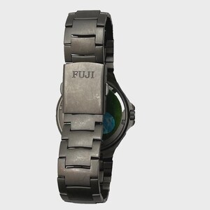 May include: A dark grey FUJI wristwatch with a metal strap. The watch face is visible, showing a green and blue design. The strap is made of interlocking metal links.