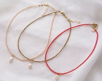 Dainty necklace made of colorful glass beads with freshwater pearl pendant, available in several colors | CLIO