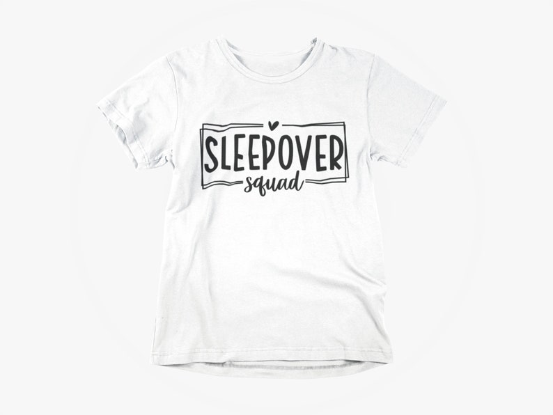 May include: White t-shirt with black text that says "Sleepover Squad" with a small heart above the word "Sleepover".