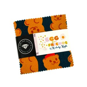 May include: A bundle of 42 fabric squares, each 6.35 cm, showcasing a repeating pattern of orange teddy bears on a dark teal backdrop. The squares are bound with a black band displaying the Ruby Star Society logo and the text "Egg and Friends by Kimberly Kight."